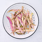 Dragon's Tongue bean pods with purple streaks on pale yellow skin in a white colander.