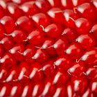 Close-up of deep red Strawberry Popcorn kernels arranged in a tight, textured pattern on the cob.