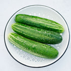 Three Straight Eight cucumbers in a white, perforated metal colander.