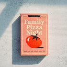 Family Pizza Night seed kit in a pink matchbox-style package with a San Marzano Tomato illustration on a textured surface.