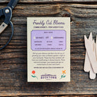 Freshly Cut Blooms seed kit box with six birch garden markers and vintage shears on a rustic wooden surface.
