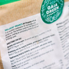 Close-up of a Gaia Green All-Purpose 4-4-4 fertilizer bag showing directions for use and a green circular logo.