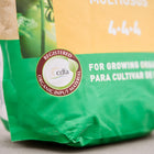 Close-up of a Gaia Green All-Purpose 4-4-4 fertilizer bag featuring a CDFA organic input material seal.