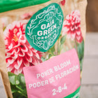 Gaia Green Power Bloom 2-8-4 fertilizer bag featuring a pink dahlia flower graphic on a tan paper package.