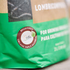 Close-up of a Gaia Green Worm Castings bag showing the green packaging and a circular CDFA organic input material seal.