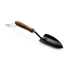Barebones Garden Trowel with a black stainless steel blade, wooden handle, and copper-colored ferrule on a white background.