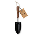 Barebones Garden Trowel with a black stainless steel blade, walnut wood handle, and a hanging tag on a white background.