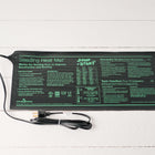 Black 9" x 19.5" Jump Start Seedling Heat Mat with instructions and a power cord on a white wooden surface.