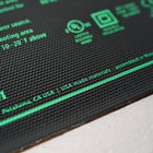 Close-up of a black 9" x 19.5" Seedling Heat Mat with green printed text, safety icons, and a textured waterproof surface.